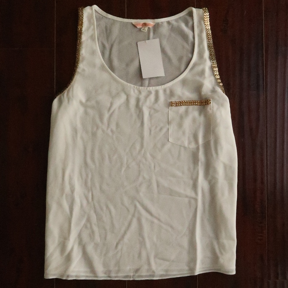 White top with gold trip